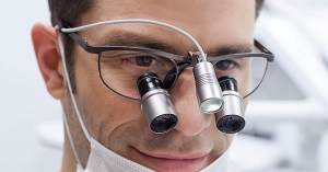 doctor using high-powered magnification loupes